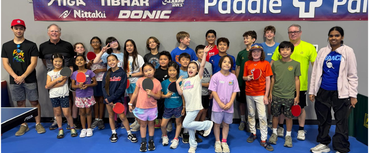 Young players and coaches celebrate a successful Paddle Palace Junior Table Tennis Camp in Tigard, Oregon.
